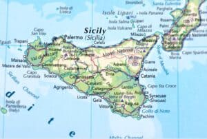 A detailed map highlighting various towns and geographic features of Sicily, with names and elevations marked in vibrant colors.