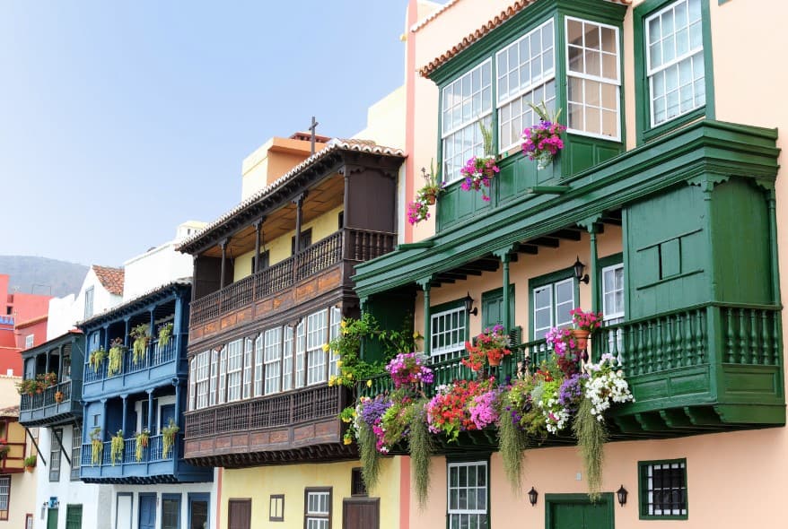 The iconic wooden balconies of Avenida Marítima in Santa Cruz de La Palma, overflowing with vibrant flowers, present a picturesque snapshot of island living and a colorful addition to the things to do in Santa Cruz de la Palma.