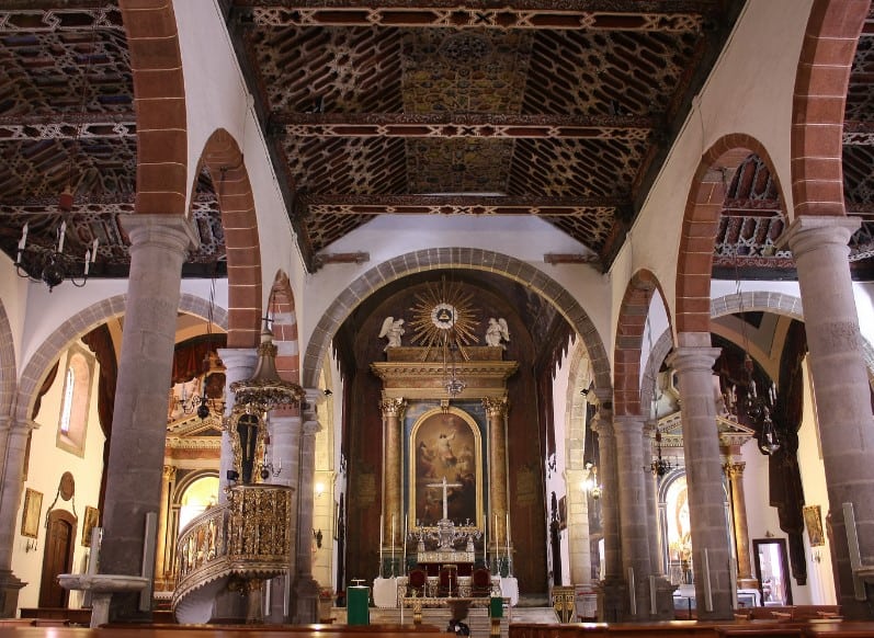 nside El Salvador Church in Santa Cruz de La Palma, the ornate gold altarpiece and intricate Mudejar-style wooden ceiling offer a glimpse into the island's rich religious artistry.