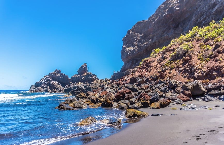Playa de Nogales in La Palma, Canary Islands, presents an idyllic escape with its dark volcanic sand and towering rock formations and makes some say yes to is La Palma worth visiting