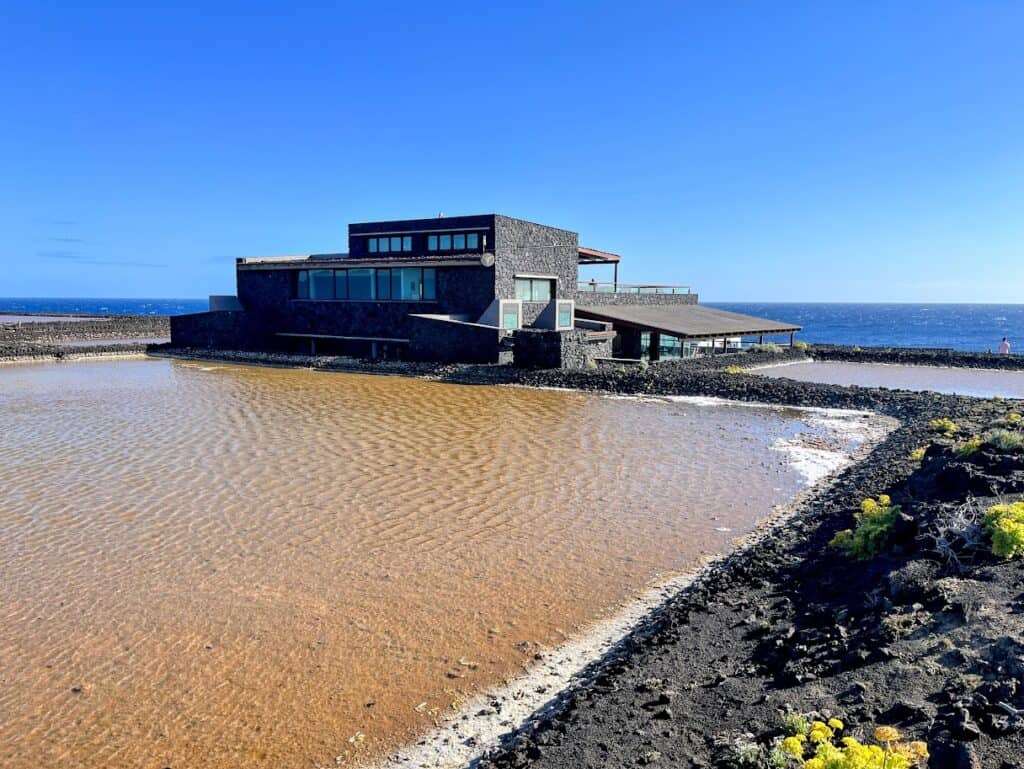 The unique architecture of El Jardín de la Sal restaurant complements the natural beauty of the Salinas de Fuencaliente, inviting visitors to savor local flavors.