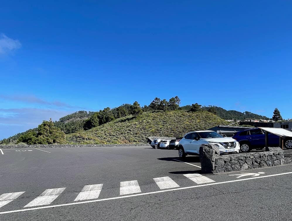 The parking area for Volcán San Antonio, showing cars parked and ready for visitors to begin their exploration of the volcano's trails and visitor center in La Palma.