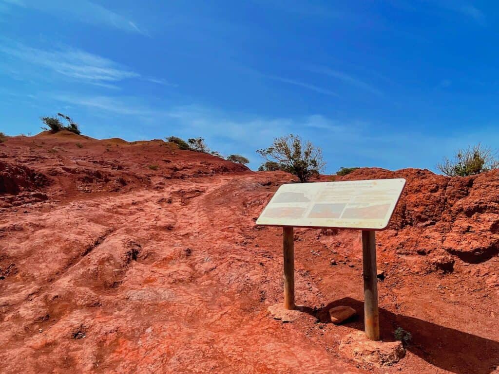 Informational sign on the red soil trails showcasing hiking near Mirador de Abrante