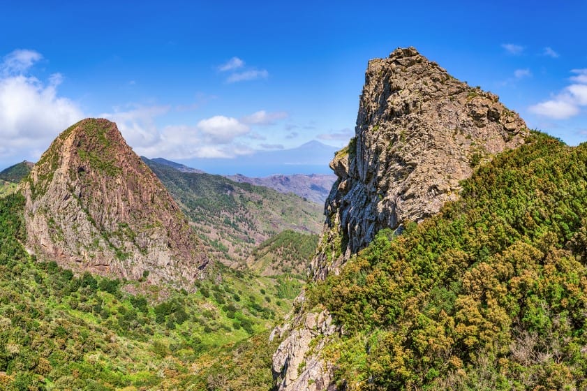 The striking Roque de Ojila, a natural monolith, towers above the landscape, a highlight for La Gomera hiking enthusiasts.