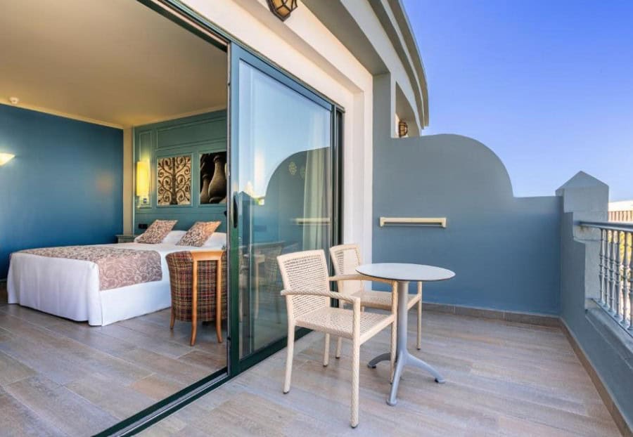 Stylish bedroom with a balcony view at Adrián Hoteles Colón Guanahaní, showcasing the best boutique hotels in Costa Adeje for adults.