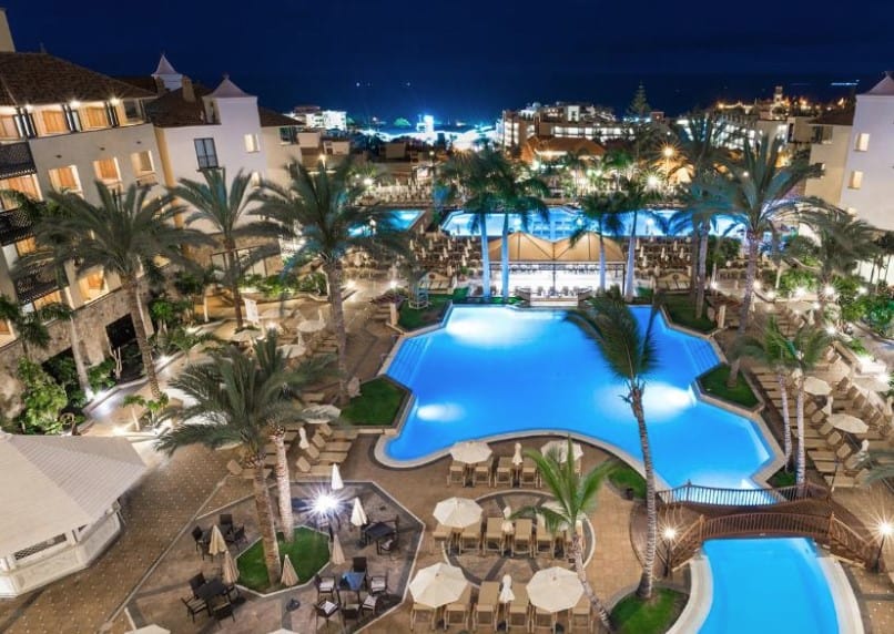 Aerial view of the illuminated pool area at night at GF Gran Costa Adeje Hotel, representing Costa Adeje hotels all inclusive.