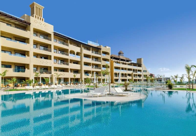 Expansive pool area with sun loungers and umbrellas at GF Victoria, showcasing the best hotels in Costa Adeje for families.