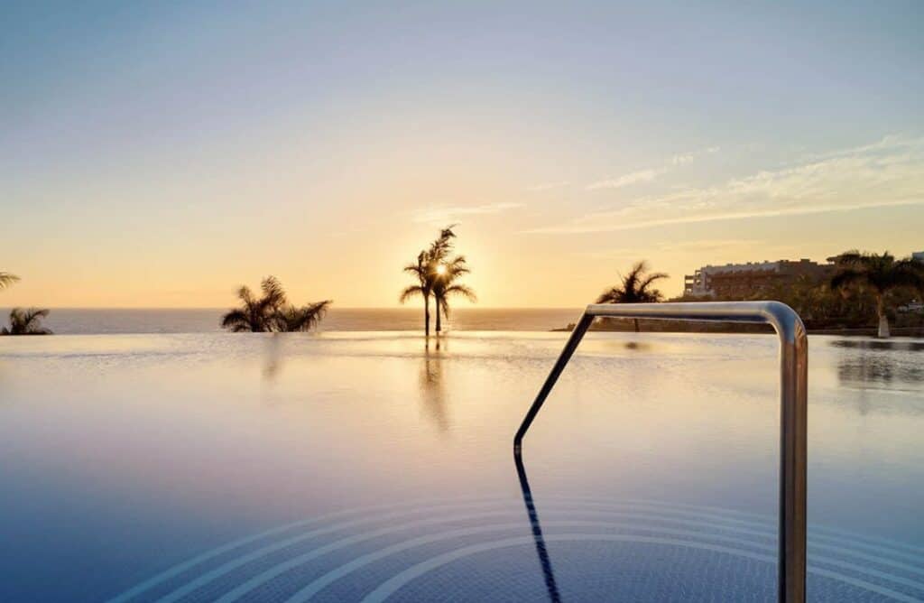 The serene infinity pool at H10 Atlantic Sunset, capturing the essence of relaxation at one of the best hotels in South Tenerife.