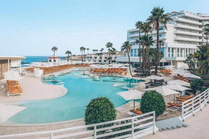 Luxurious pool area with sun loungers and umbrellas at Iberostar Selection Sábila, showcasing the best hotels in South Tenerife for adults.