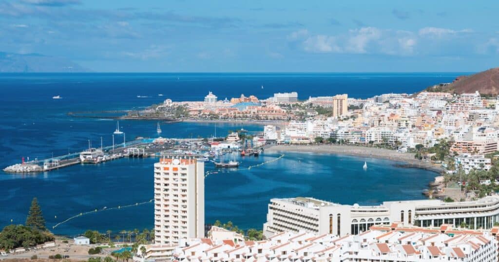 The bustling harbor and charming town of Los Cristianos showcase why it's a popular destination among the best hotels in Los Cristianos on the beach.