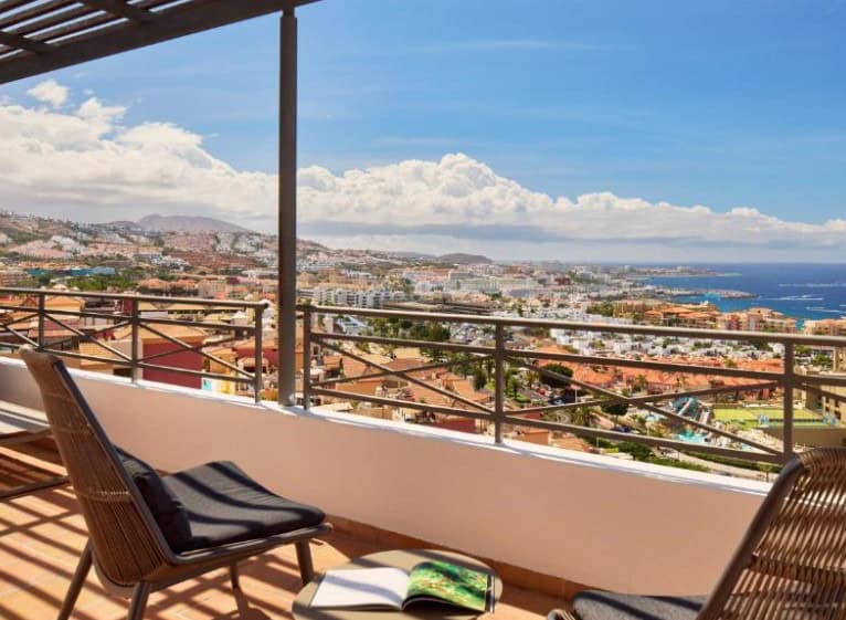 A stunning view from a balcony overlooking Costa Adeje and the ocean at Melia Jardines del Teide, showcasing hotels in Costa Adeje Tenerife.