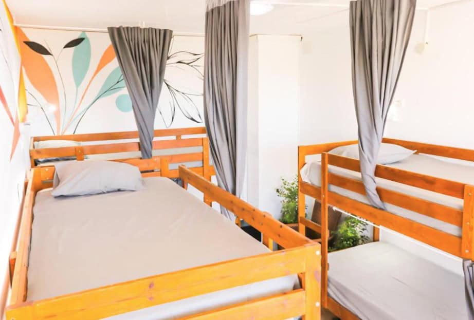 Ocean Nomads Coworking, one of the cheap hotels in Los Cristianos, provides bright rooms with wooden bunk beds and vibrant wall art.