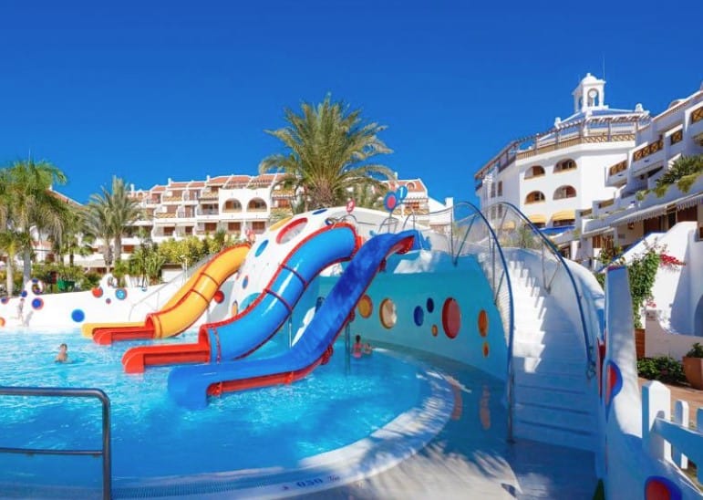 The brightly colored water slides at Parque Santiago III offer endless fun for kids, making it a top choice for hotels in Los Cristianos.