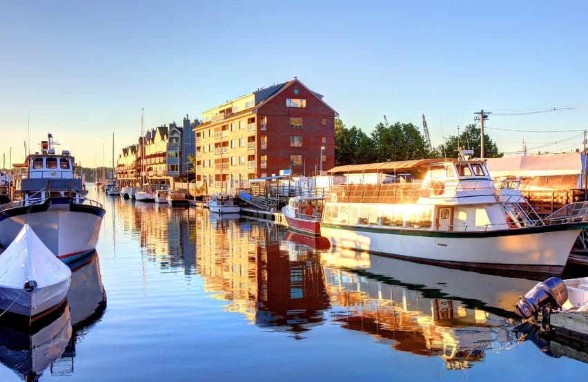 The tranquil waterway of Portland, Maine, reflecting the sunrise, a peaceful stop on the trip from Acadia to Boston.