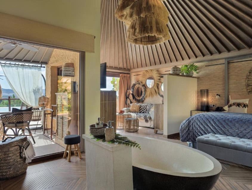A stylish, eco-luxury room with a bathtub and terrace at Royal River, highlighting boutique hotels in South Tenerife.