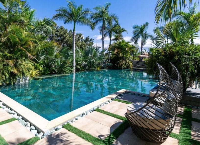 A serene pool area surrounded by lush greenery at Royal River, representing luxury hotels in South Tenerife.