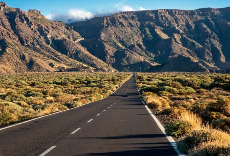 Road through the rocky landscape of Teide National Park, emphasizing the unique terrain and a way of getting around Tenerife.
