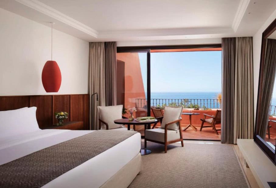 Modern hotel room with a balcony and ocean view at Tivoli La Caleta Resort, highlighting Costa Adeje hotels 5-star all-inclusive.