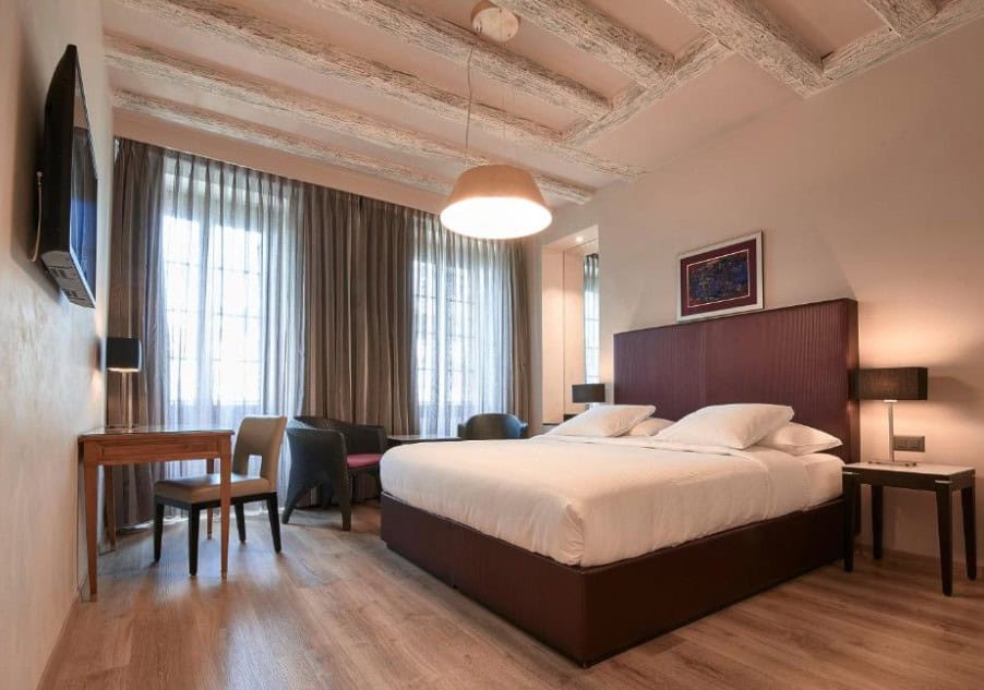 A cozy and elegant room at Hotel d'Allèves, showcasing the blend of historic charm and modern comfort. This boutique hotel is a quieter option among Geneva Switzerland hotels on the lake, offering a more intimate and personal stay.
