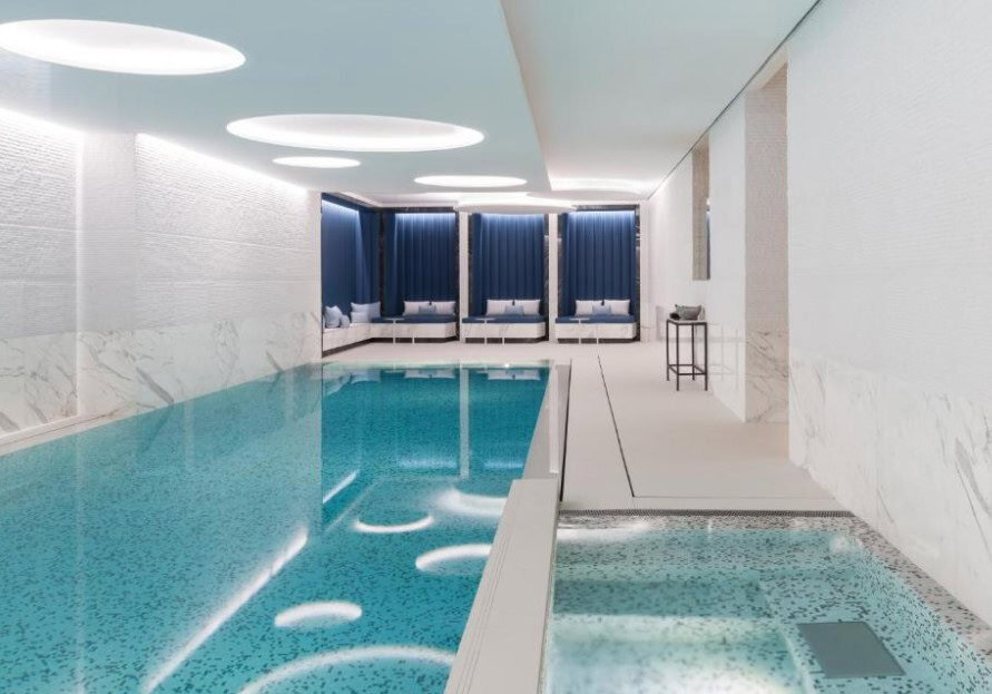 The luxurious indoor pool at The Woodward, one of Geneva on the lake luxury hotels. The hotel features world-class wellness facilities, including this serene pool area, ideal for relaxation.