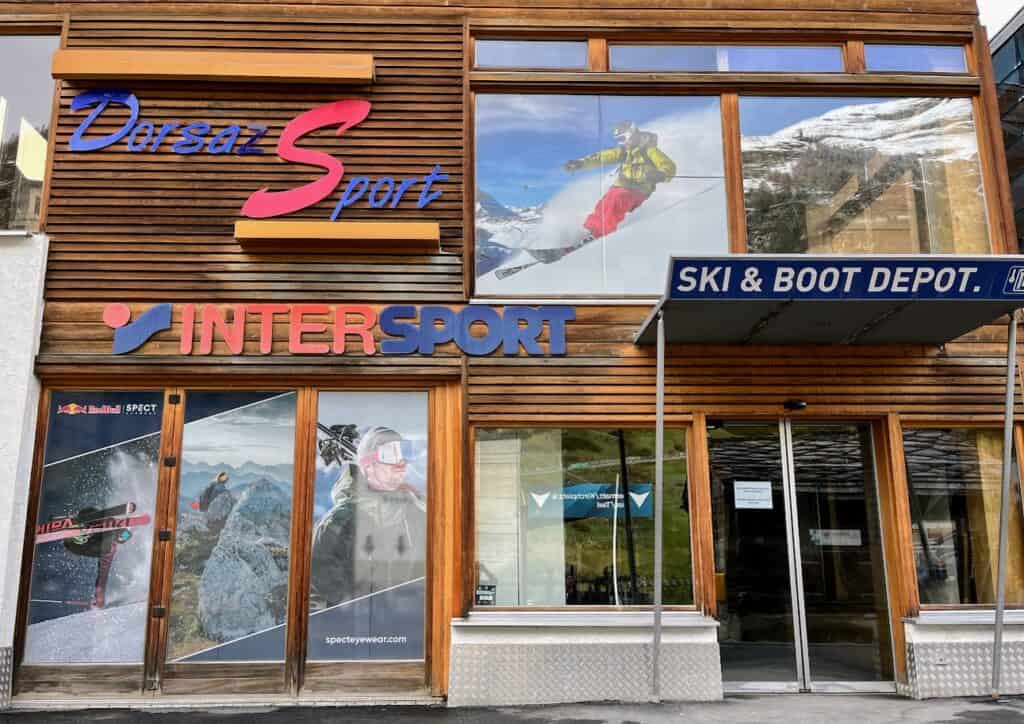 Dorsaz Sport INTERSPORT Ski Rental shop in Zermatt displays an array of colorful ski gear and equipment, attracting winter sports enthusiasts. The vibrant images of skiers on the windows evoke excitement for those planning how many days in Zermatt winter would be ideal for hitting the slopes.