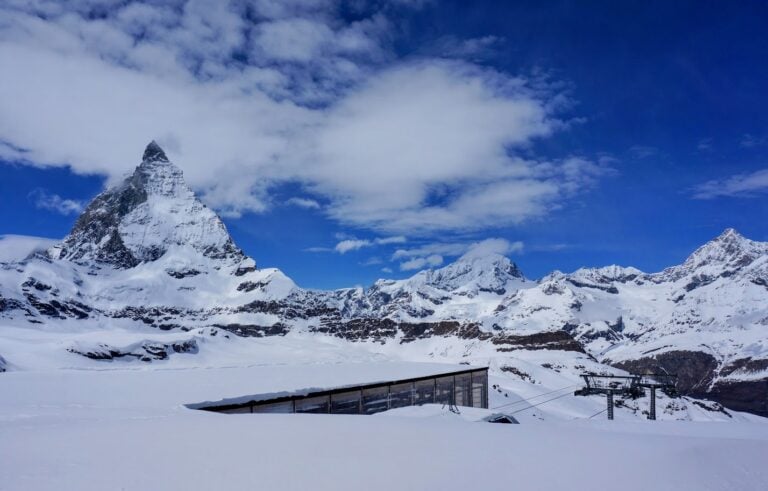 Snow-covered view of the Matterhorn towering above a ski lift station on a clear winter day. This is one of the best day trips from Zermatt for panoramic alpine scenery.